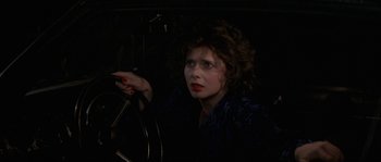 Movie still from “Blue Velvet” (1986), directed by David Lynch – A woman with red lipstick is driving a car; Close Up shot, High angle