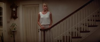 Movie still from “Blue Velvet” (1986), directed by David Lynch – A woman standing on the stairs of a house; Medium shot, Low angle
