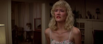 Movie still from “Blue Velvet” (1986), directed by David Lynch – A woman with blonde hair and a pink and white floral dress; Close Up shot, Low angle