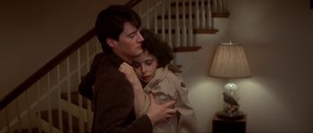 A man and a woman hugging in a room