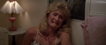 Movie still from “Blue Velvet” (1986), directed by David Lynch – A woman with blonde hair is crying in a room; Close Up shot, High angle