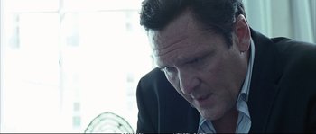 Movie still from “Boarding Gate” (2007), directed by Olivier Assayas – A person wearing a suit and tie; Close Up shot, Low angle