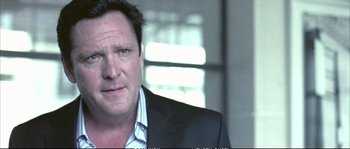 Movie still from “Boarding Gate” (2007), directed by Olivier Assayas – A person wearing a suit and tie; Close Up shot, Over the shoulder angle