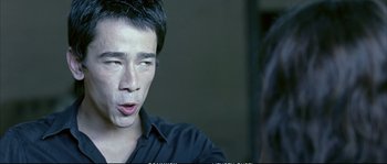 Movie still from “Boarding Gate” (2007), directed by Olivier Assayas – A person talking to a camera; Close Up shot, Over the shoulder angle