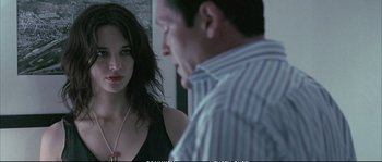 Movie still from “Boarding Gate” (2007), directed by Olivier Assayas – A man and a woman standing next to each other in a room; Close Up shot, Over the shoulder angle