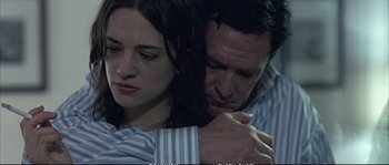 Movie still from “Boarding Gate” (2007), directed by Olivier Assayas – A man and a woman embracing each other; Close Up shot, Low angle