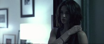 Movie still from “Boarding Gate” (2007), directed by Olivier Assayas – A beautiful woman with long dark brown hair; Close Up shot, Low angle