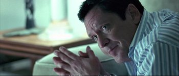 Movie still from “Boarding Gate” (2007), directed by Olivier Assayas – A person with their hands clasped; Close Up shot, Over the shoulder angle