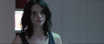 Movie still from “Boarding Gate” (2007), directed by Olivier Assayas – A beautiful young woman with long black hair; Close Up shot, Over the shoulder angle
