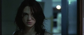 Movie still from “Boarding Gate” (2007), directed by Olivier Assayas – A person with long dark hair; Close Up shot, Low angle
