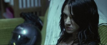 Movie still from “Boarding Gate” (2007), directed by Olivier Assayas – A person with long black hair; Close Up shot, Over the shoulder angle