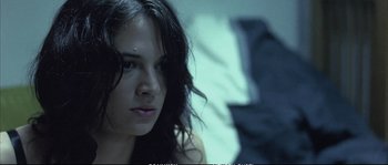 Movie still from “Boarding Gate” (2007), directed by Olivier Assayas – A person with long black hair; Close Up shot, Low angle