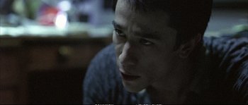 Movie still from “Boarding Gate” (2007), directed by Olivier Assayas – A person looking at the camera; Close Up shot, High angle