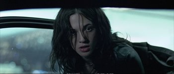 Movie still from “Boarding Gate” (2007), directed by Olivier Assayas – A person with long black hair; Close Up shot, High angle