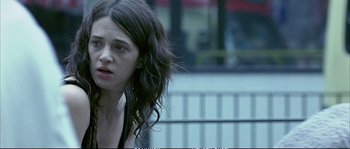 Movie still from “Boarding Gate” (2007), directed by Olivier Assayas – A woman with long black hair is looking at the camera; Close Up shot, Low angle