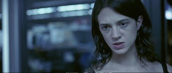 Movie still from “Boarding Gate” (2007), directed by Olivier Assayas – A person with wet hair; Close Up shot, Over the shoulder angle