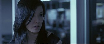 Movie still from “Boarding Gate” (2007), directed by Olivier Assayas – A person with long black hair; Close Up shot, High angle