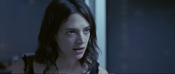 Movie still from “Boarding Gate” (2007), directed by Olivier Assayas – A person with long black hair; Close Up shot, Over the shoulder angle