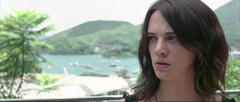 Movie still from “Boarding Gate” (2007), directed by Olivier Assayas – A person with long brown hair; Close Up shot, Low angle