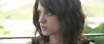 Movie still from “Boarding Gate” (2007), directed by Olivier Assayas – A person with long hair; Close Up shot, Low angle