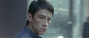 Movie still from “Boarding Gate” (2007), directed by Olivier Assayas – A person wearing a jacket; Close Up shot, High angle