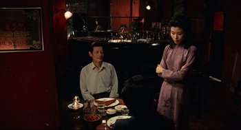 Movie still from “Boat People” (1982), directed by Ann Hui – A man and a woman sitting at a dinner table; Medium shot, Over the shoulder angle