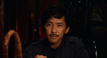 Movie still from “Boat People” (1982), directed by Ann Hui – A person with a mustache; Close Up shot, High angle