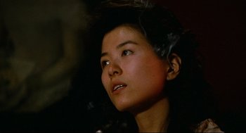 Movie still from “Boat People” (1982), directed by Ann Hui – A woman with a cigarette in her mouth; Close Up shot, Low angle