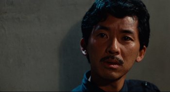 Movie still from “Boat People” (1982), directed by Ann Hui – A person with a mustache; Close Up shot, High angle