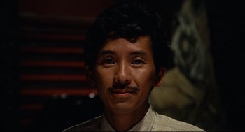 Movie still from “Boat People” (1982), directed by Ann Hui – A person with a mustache; Close Up shot, Low angle