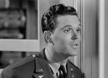 Movie still from “Bombardier” (1943), directed by Lambert Hillyer – A black and white photo of a man in a uniform; Close Up shot, Low angle