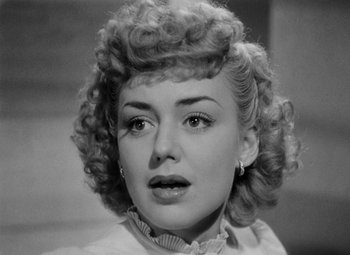 Movie still from “Bombardier” (1943), directed by Lambert Hillyer – A black and white photo of a woman's face; Close Up shot, High angle