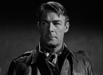 Movie still from “Bombardier” (1943), directed by Lambert Hillyer – Black and white photograph of a man wearing a leather jacket; Close Up shot, Low angle