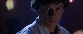 Movie still from “Boogie Nights” (1997), directed by Paul Thomas Anderson – A person wearing a lab coat; Close Up shot, Low angle