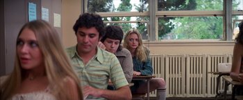 Movie still from “Boogie Nights” (1997), directed by Paul Thomas Anderson – A group of people sitting in a classroom; Medium shot, Over the shoulder angle