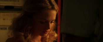 Movie still from “Boogie Nights” (1997), directed by Paul Thomas Anderson – A woman's face in the dark; Close Up shot, Over the shoulder angle