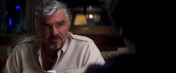 Movie still from “Boogie Nights” (1997), directed by Paul Thomas Anderson – An older man sitting in front of a mirror; Close Up shot, Over the shoulder angle