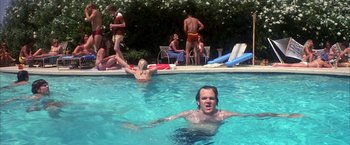 Movie still from “Boogie Nights” (1997), directed by Paul Thomas Anderson – A group of people in a swimming pool; Wide shot, High angle