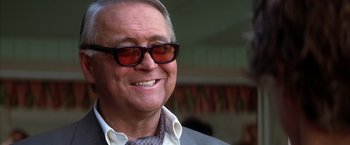Movie still from “Boogie Nights” (1997), directed by Paul Thomas Anderson – An older man wearing sunglasses and a jacket; Close Up shot, Low angle