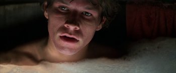 Movie still from “Boogie Nights” (1997), directed by Paul Thomas Anderson – A person laying in a bed; Close Up shot, Overhead angle