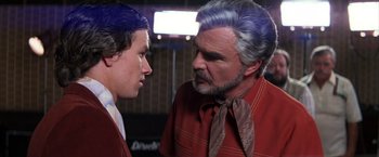 Movie still from “Boogie Nights” (1997), directed by Paul Thomas Anderson – A man and a boy are looking at each other; Close Up shot, Over the shoulder angle