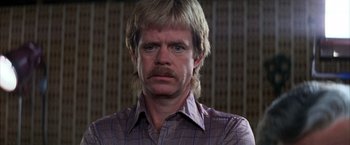 Movie still from “Boogie Nights” (1997), directed by Paul Thomas Anderson – A person wearing a shirt; Close Up shot, Low angle