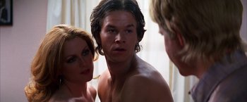 Movie still from “Boogie Nights” (1997), directed by Paul Thomas Anderson – A man and two women looking in a mirror; Close Up shot, Over the shoulder angle