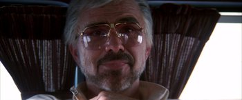 Movie still from “Boogie Nights” (1997), directed by Paul Thomas Anderson – A person wearing glasses; Close Up shot, Low angle