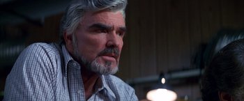 Movie still from “Boogie Nights” (1997), directed by Paul Thomas Anderson – An older man with gray hair looking at the camera; Close Up shot, Low angle