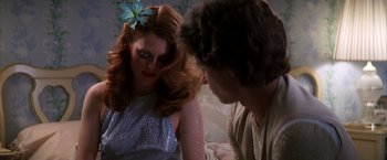 Movie still from “Boogie Nights” (1997), directed by Paul Thomas Anderson – A man and a woman looking at one another; Close Up shot, Over the shoulder angle