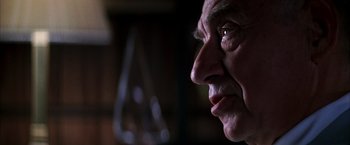 Movie still from “Boogie Nights” (1997), directed by Paul Thomas Anderson – An older man looking into the distance with his eyes wide open; Extreme Close Up shot, Low angle