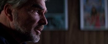 Movie still from “Boogie Nights” (1997), directed by Paul Thomas Anderson – An older man with a beard and mustache looking to his left; Extreme Close Up shot, Low angle