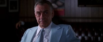 Movie still from “Boogie Nights” (1997), directed by Paul Thomas Anderson – An older man wearing a suit and tie; Close Up shot, Low angle