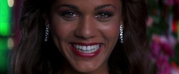 Movie still from “Boogie Nights” (1997), directed by Paul Thomas Anderson – A woman's face with bright green eyes; Close Up shot, Overhead angle